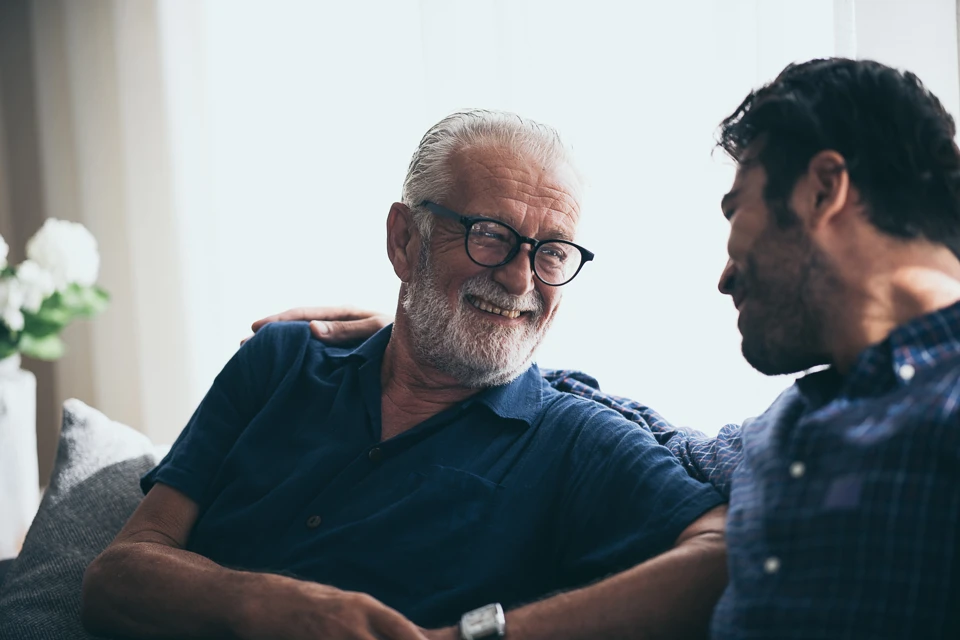 Older and younger men having a conversation